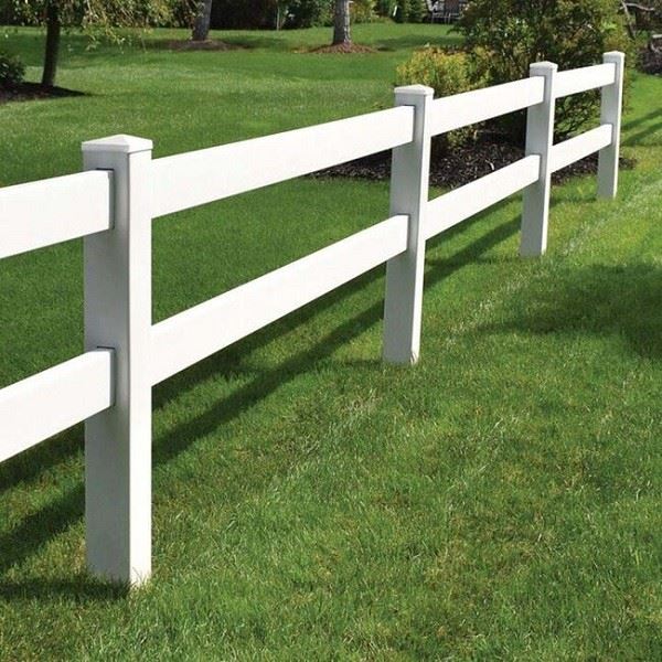 White 2-rail vinyl ranch fence detail showing post-to-rail connection bracket with aluminum-reinforced PVC rail profile and routed post holes demonstrating structural connection between horizontal rail and vertical post
